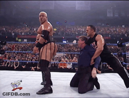 Wrestlers In A Wrestling Ring With A W Logo On The Bottom Right GIF