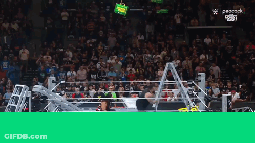 Wrestlers In Ring With Peacock Screen GIF