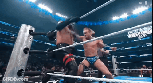 Wrestlers In Ring With WrestleMania Vegas Sign GIF