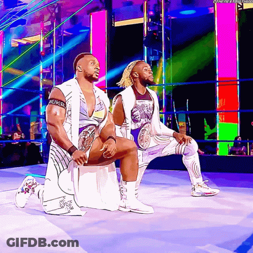 Wrestlers Kneeling In Ring With Hulk Arm GIF