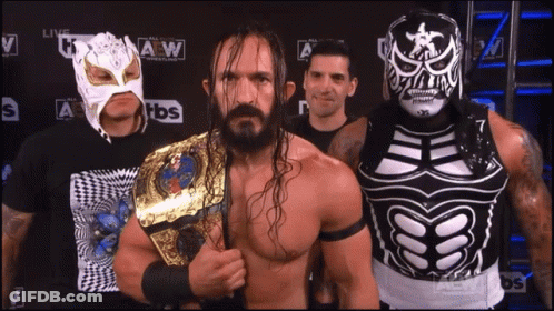 Wrestlers Posing In Front Of TBS Logo GIF