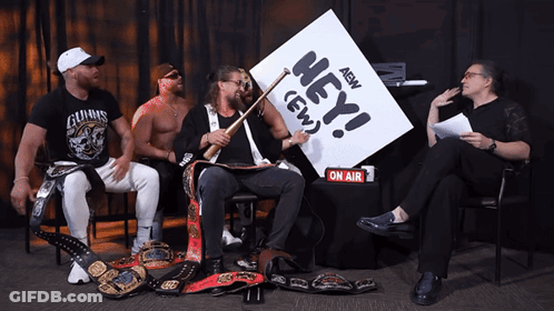 Wrestlers Sitting Around Table Saying Hey AEW GIF