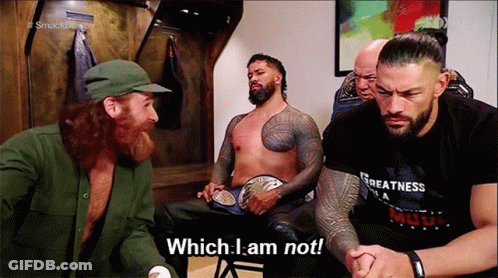 Wrestlers Sitting One Holding Belt GIF
