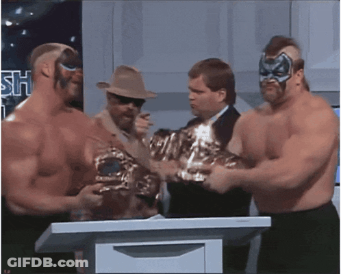Wrestlers Standing Around Podium With Sh Sign GIF