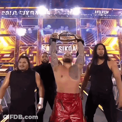Wrestlers Standing In Front Of And New Sign GIF