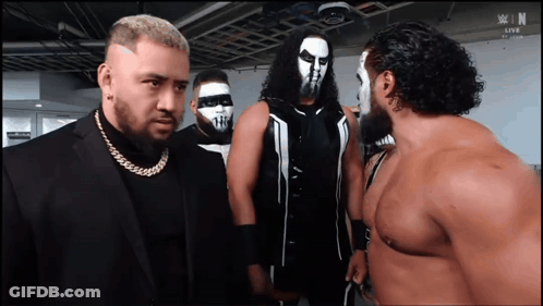 Wrestlers Standing In Front Of N Sign GIF