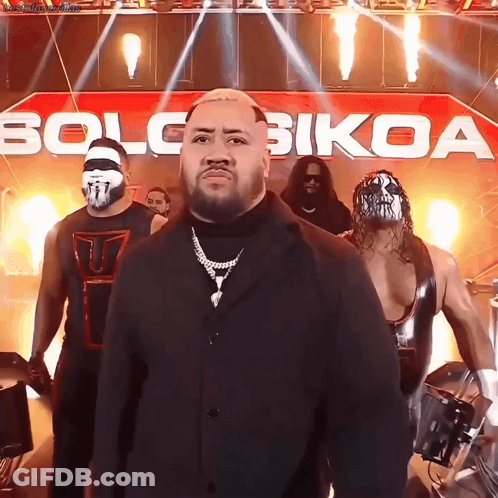 Wrestlers Standing In Front Of Solo Bikoa Banner GIF