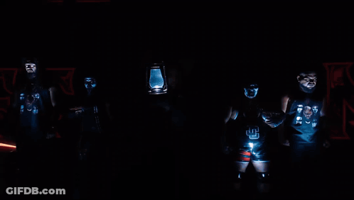 Wrestlers Standing In Front Of Ulti Sign GIF
