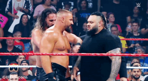 Wrestlers Standing In Ring Talking GIF