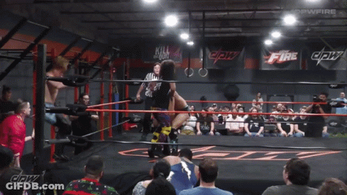 Wrestling Match In Front Of Fire Sign GIF