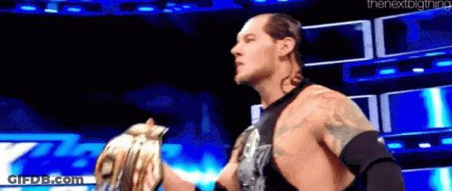 Wrestling Match Man Holding Woman's Hand On Stage GIF