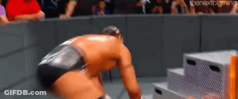 Wrestling Match With Crowd And Kneeling Wrestler GIF