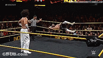 WWE Wrestling Match With Referee Behind Ropes GIF