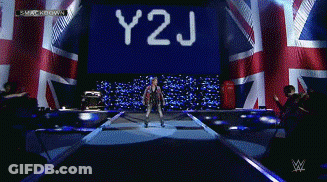 Y2J Displayed On Screen Behind Man On Stage GIF