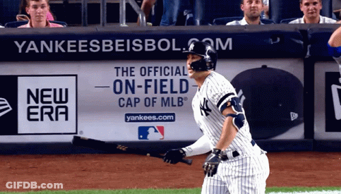 Yankees Player Holding Bat In Front Of Advertisement GIF