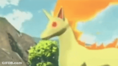 Yellow And Orange Pokémon Standing In Grass GIF
