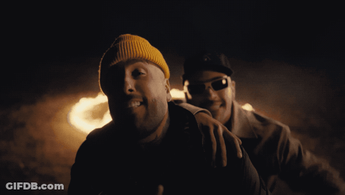 Yellow Beanie And Sunglasses Man Beside Another GIF
