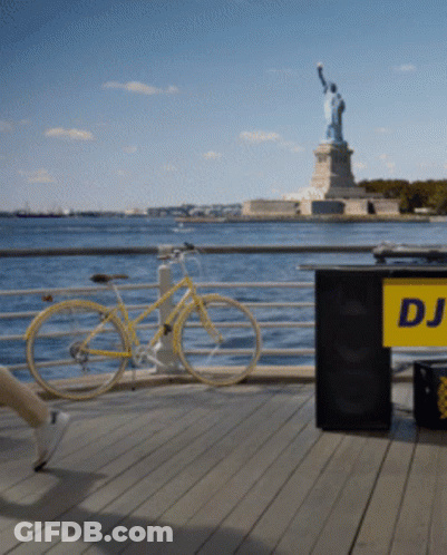 Yellow Bicycle Parked Next To DJ Table GIF