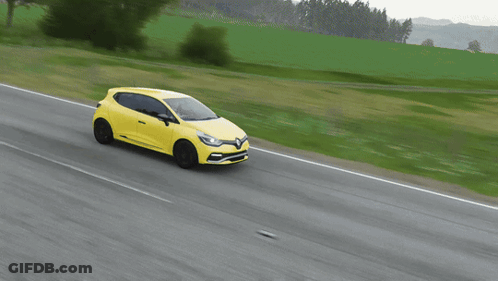 Yellow Car Driving On Road With Grassy Field GIF