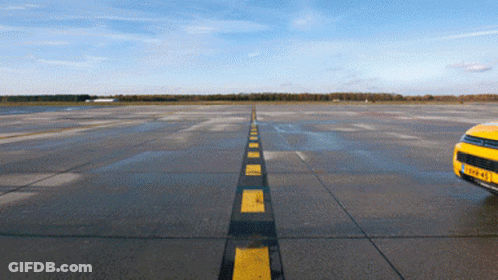 Yellow Car On Runway With Black And Yellow Stripe GIF