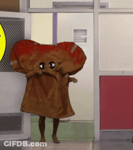 Yellow Cartoon Character With Book And Cupcake On Head GIF