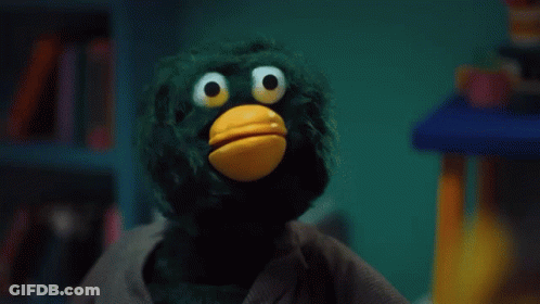 Yellow Duck With Green Hair Holding Stick GIF