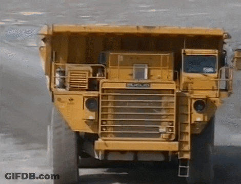 Yellow Dump Truck By Building Saying Matsu GIF