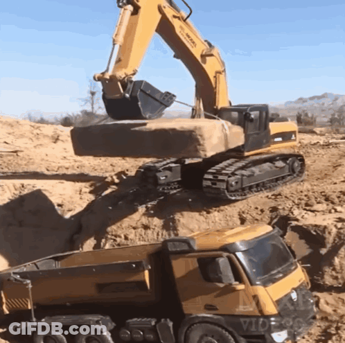 Yellow Dump Truck Loaded With Sand By Excavator GIF
