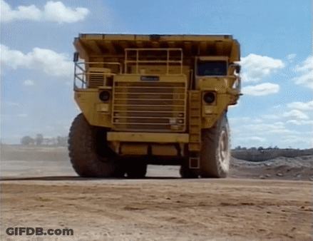 Yellow Dump Truck On Dirt Road GIF