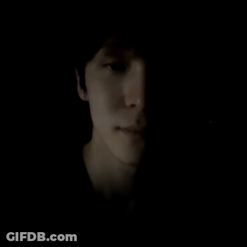 Yellow Face Cartoon With White Hand In Dark GIF