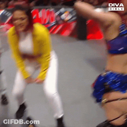 Yellow Jacket Woman Dancing With Blue Bikini Woman GIF