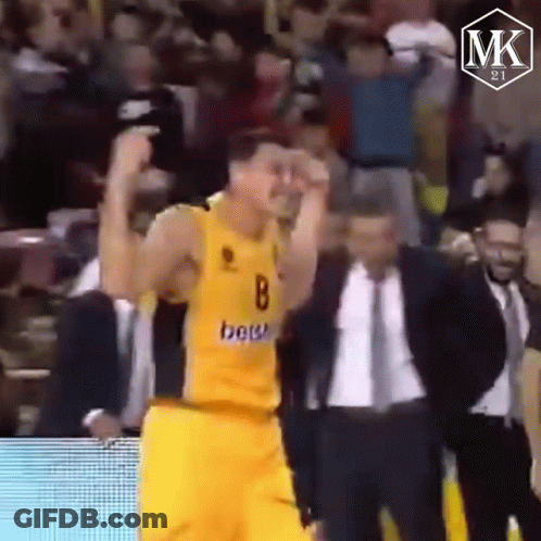 Yellow Jersey Man Raising Hands In Crowd GIF