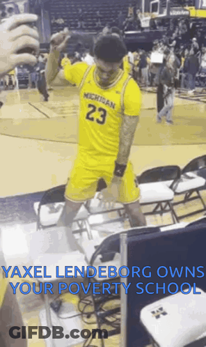 Yellow Michigan Jersey Man Dancing On Basketball Court GIF