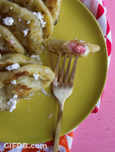 Yellow Plate With Food And Fork On Pink Tablecloth GIF
