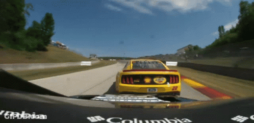 Yellow Race Car Number 22 Driving Down Track GIF