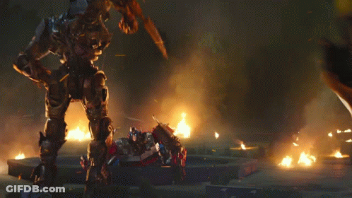 Yellow Robot Fighting Black Robot In Flames GIF