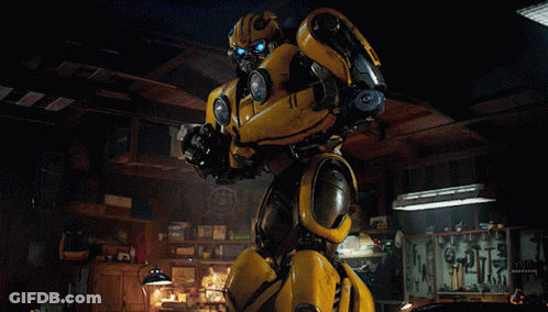 Yellow Robot Standing In Dark Room With Tools GIF