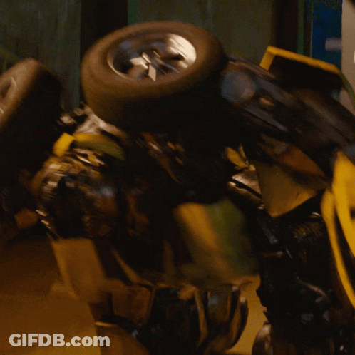 Yellow Robot With Blue Eyes Holding Tire GIF