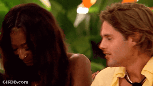 Yellow Shirt Man Talking To Black Top Woman GIF
