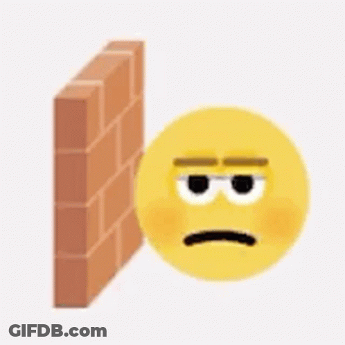 Yellow Smiley Sad Face Beside Brick Wall GIF