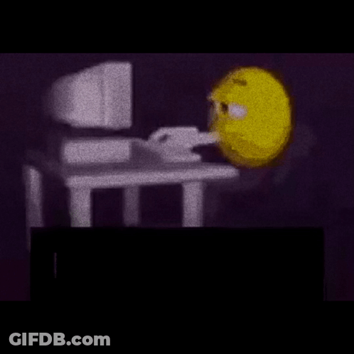 Yellow Smiley Sitting At Desk With Computer GIF