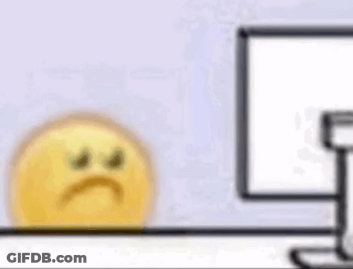 Yellow Smiley Sitting In Front Of Computer GIF