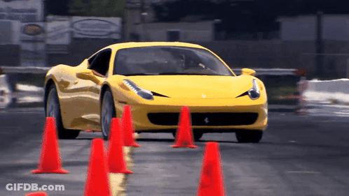 Yellow Sports Car Driving Through Red Cones GIF