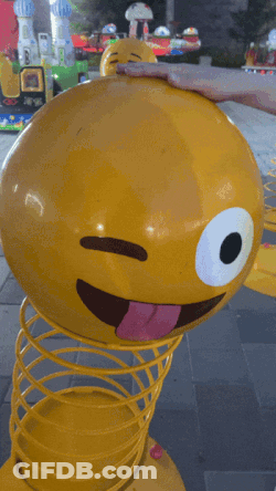 Yellow Spring Toy Smiley Face Sticking Tongue Out GIF