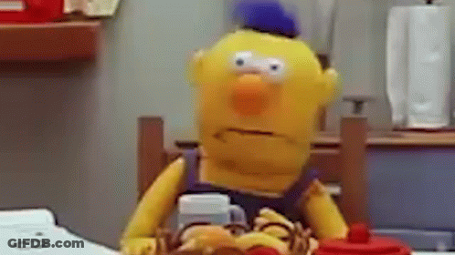 Yellow Stuffed Animal At Table With Hamburger And Coffee GIF
