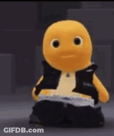 Yellow Stuffed Animal In Black Vest And Pants Sitting GIF