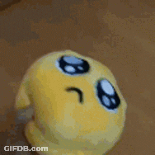 Yellow Stuffed Animal On Green Blanket GIF