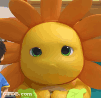 Yellow Stuffed Animal With Green Eyes Beside Child GIF
