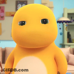 Yellow Stuffed Animal With Green Eyes On Couch GIF