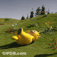 Yellow Teddy Bear Laying In Grass GIF
